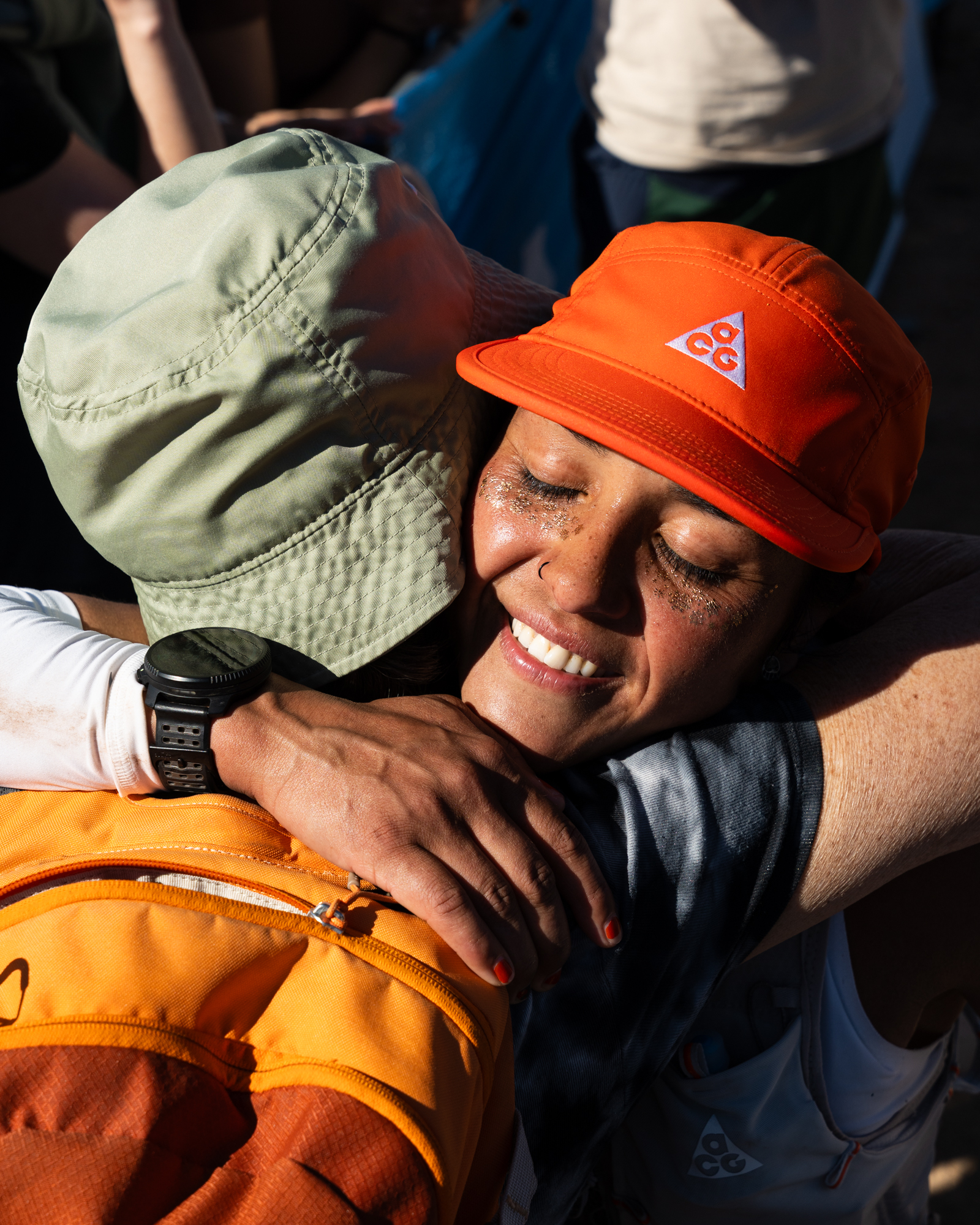 Two people embrace at the end of an endurance event.